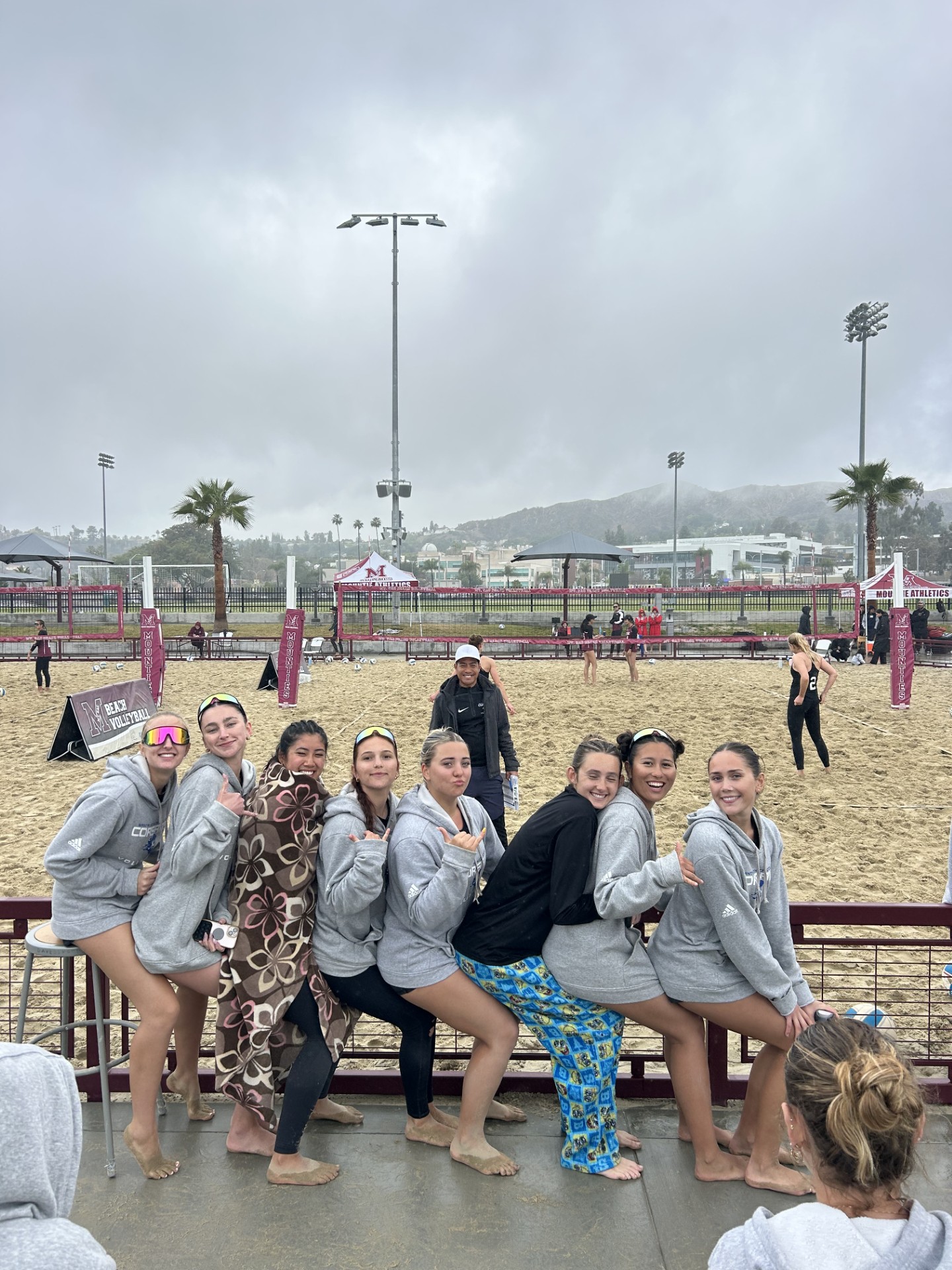 SMC Women's Volleyball Team posing for picture with beach in the background