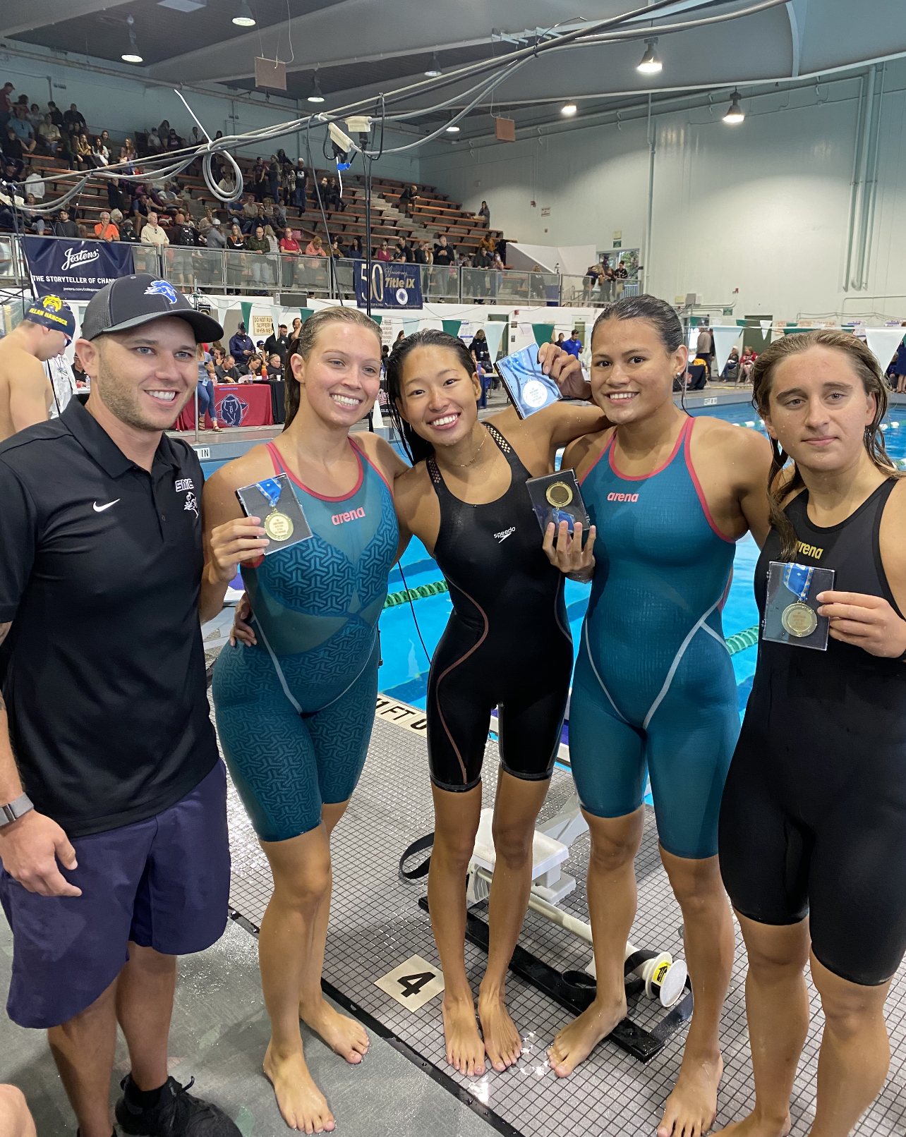 Coach Brian Eskridge, Valerie Burchard, Risa Akatsu, Reva Reignier, Ema Klimauskas after winning the 800 Meter Relay at the State Championships