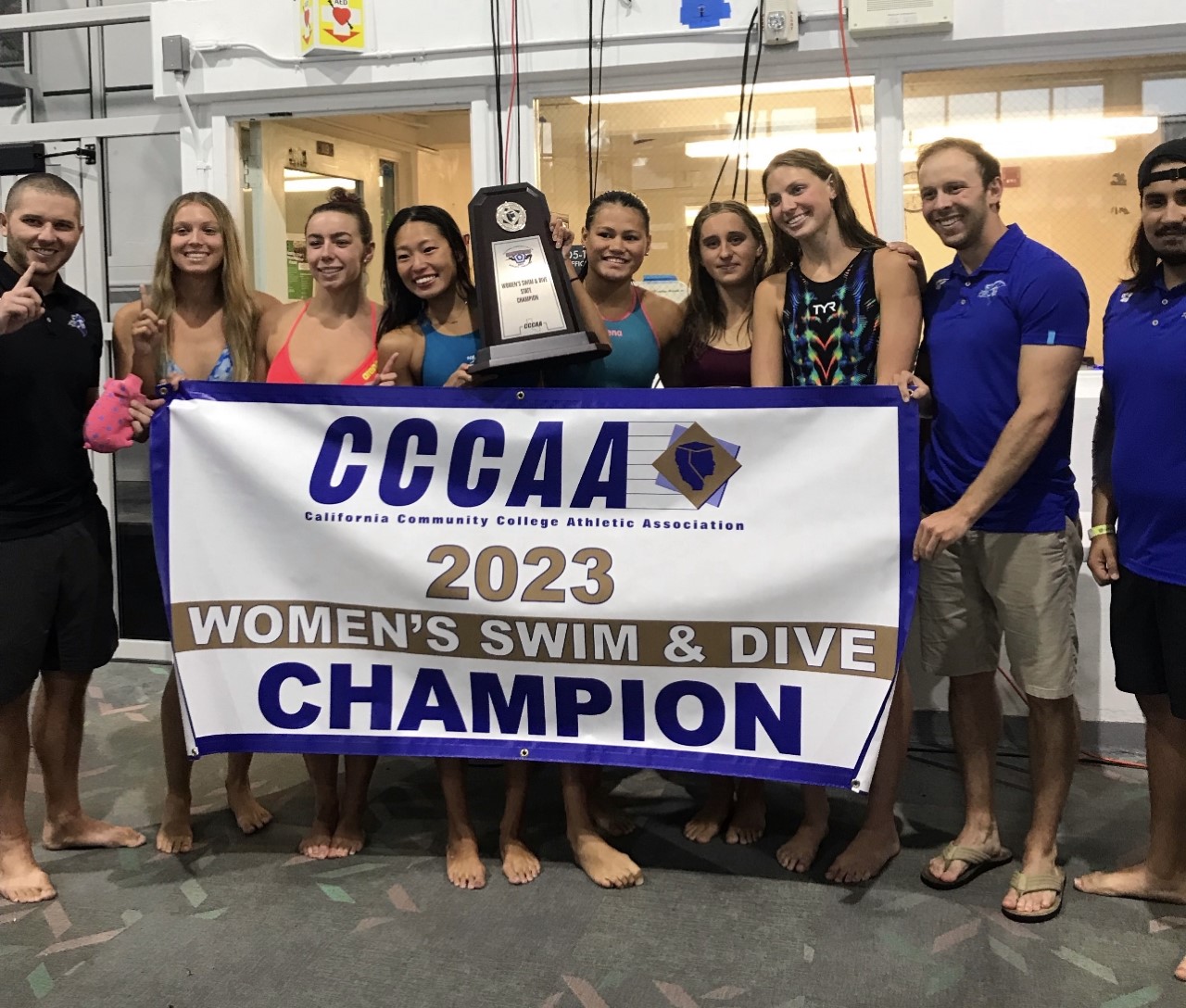 2023 Women's Swim and Dive Team Champions holding Championship Banner.